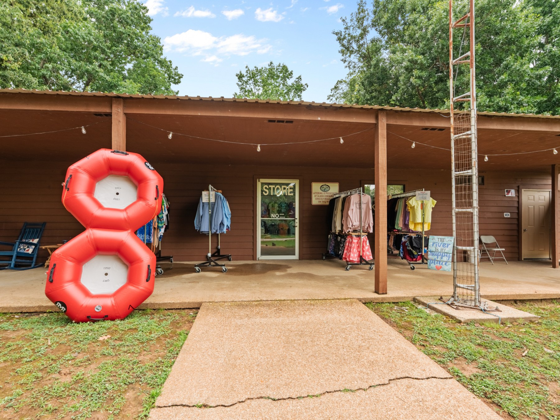 Storefront with life vests and two large red rings displayed outside.